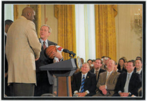 John Clark Sr looks on as President Bush shakes hands with Shaq.